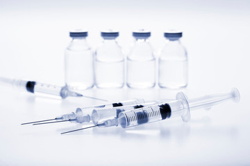 Glass medicine vials and Syringe on white background