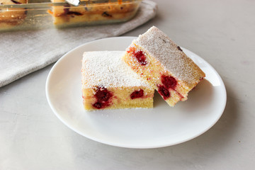 Cupcake with cherries and powdered sugar