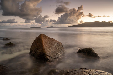amazing travel landscape photo with Sunset of the iconic rocks of seychelles , Seascape on sea with long exposure and water wave