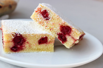 Cupcake with cherries and powdered sugar