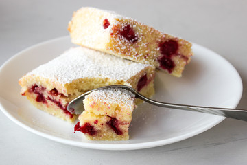 Cupcake with cherries and powdered sugar