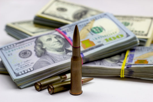 Diverse weapon bullets on American dollars background. Military industry, war, global arms trade and crime concept.