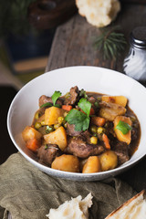 traditional irish beef and guinness beer stew with carrots, potatoes and green peas