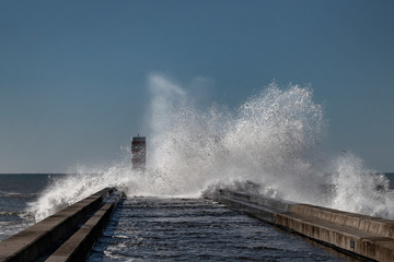 Fototapeta na wymiar Splashing Atlantic ocean waves in estuary of Douru river, Porto, Portugal.