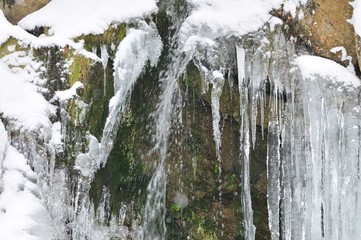 Fototapeta na wymiar Beautiful mountain waterfall covered in ice