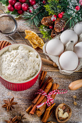 Fototapeta na wymiar Christmas baking background. Ingredients for cooking xmas baking. Flour, eggs, sugar, berry, spices on wooden background with christmas decor,. Top view copy space.