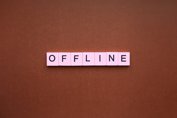 Offline word wooden cubes on brown background