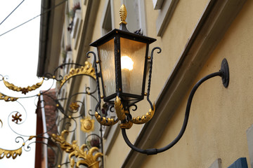 Old street lamps illuminate the way for passersby