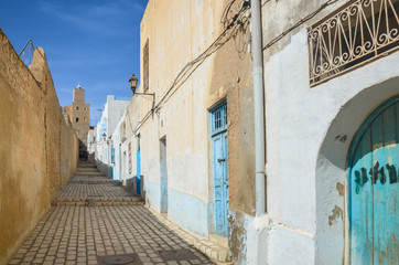 Typical street in the medieval medina of Sousse, Tunisia. The kasbah tower is visible in the background.