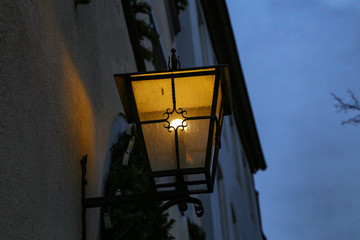 Old street lamps illuminate the way for passersby