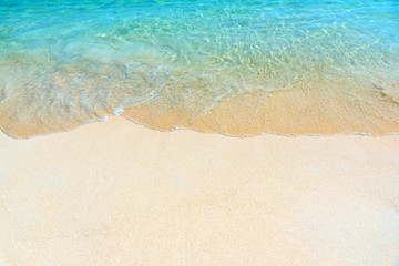 Fantastic golden sand beach with clear blue water. Summer outdoor nature holiday serenity. Beautiful clean sandy beach with soft blue ocean wave. Background, copy space or space for text.