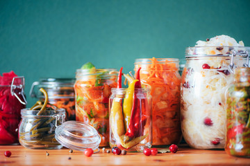 Probiotics food background. Korean carrot, kimchi, beetroot, sauerkraut, pickled cucumbers in glass jars. Winter fermented and canning food concept. Banner with copy space