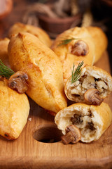 Delicious small savory hand pies filled with potatoes, champignons mushrooms and onion. 