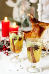 christmas hot cider. hot winter drink Cranberry Apple Cider Punch. Garnish with apples, oranges, and cranberries. hot apple cider with spices on a festive table on Christmas or New Year.