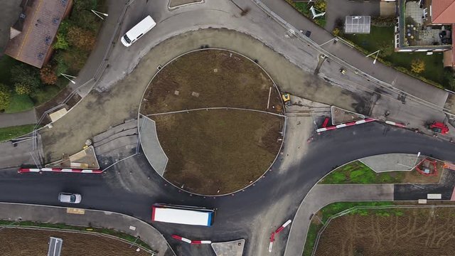 Time lapse top down aerial view of a newly constructed roundabout, with traffic being managed as contraflows.