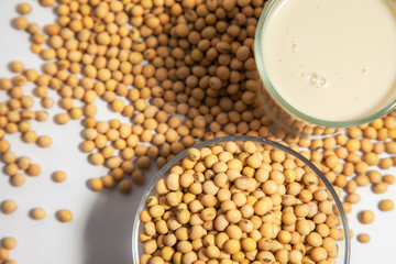 Soy milk pouring in glass and soy bean or soya bean . Alternative Soy milk healthy concept.