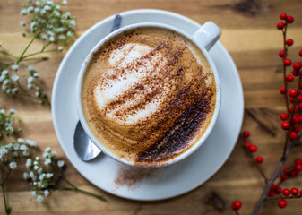 cup of coffee with cake on wooden table