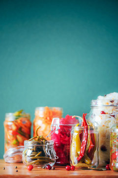 Naklejka Probiotics food background. Korean carrot, kimchi, beetroot, sauerkraut, pickled cucumbers in glass jars. Winter fermented and canning food concept. Banner with copy space