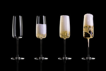 Four glasses of champagne isolated on black background. The empty glass, half glass, full glass, a glass with a large foam.