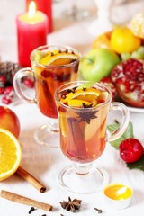 hot winter drink Cranberry Apple Cider Punch. Garnish with apples, oranges, and cranberries. hot apple cider with spices on a festive table on Christmas or New Year.
