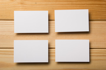 Business card blank on wooden background. Corporate Stationery, Branding Mock-up. Creative designer desk. Flat lay. Copy space for text