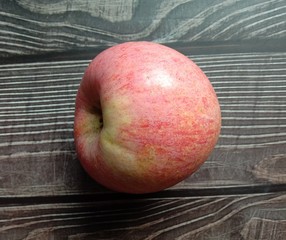 Red apple (Malus pumila) on wallpaper give a sweet taste with vitamin C to help prevent inflammation Reduce wrinkles Reduce scurvy. Helps the capillary walls become stronger. closeup.