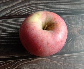 Red apple (Malus pumila) on wallpaperive a sweet taste with vitamin C to help prevent inflammation...