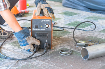 Metalworker Preparing welding equipment For use in construction