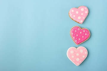 Pink cookie heart shaped with different patterns, blue background