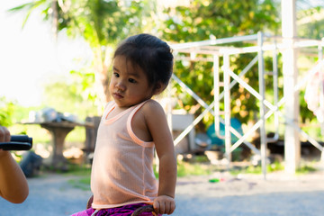 Standing kindergarten young Asian girl