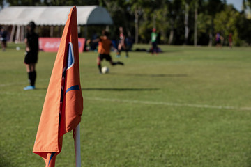 Girl football tournament in action during summer time. Girl players in a football pitch, kicking, defending, running and shooting ball with passion.