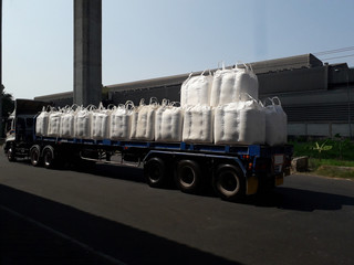 Fototapeta na wymiar Trailer loading goods fertilizer urea sack jumbo to customers. 