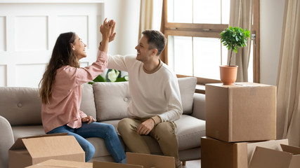 Happy couple give high five celebrate moving into new home