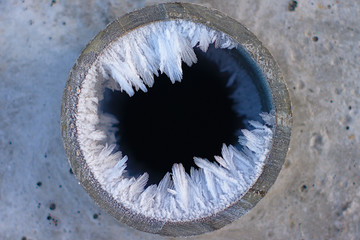 Water crystallization in the floor, ice inside the pipe section.
