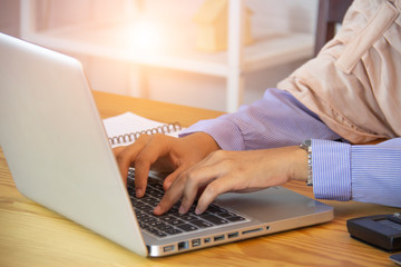 Close up of business woman hands typing on laptop computer