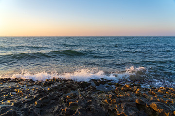 Small waves on a rocky seashore at morning