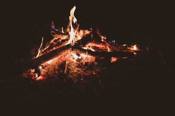 burning fire with small flames and ashes