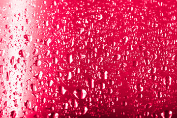 Drops of water on a glass background. Red. Selective focus. Toned
