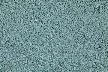 Blue textured wall, texture, background. Structural plaster, covered with water-based paint. Rough, uneven surface in blue color