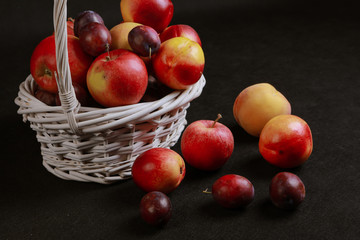 Fototapeta na wymiar full basket of apples on a black background
