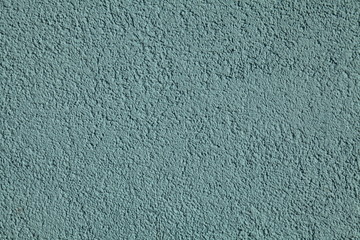 Blue textured wall, texture, background. Structural plaster, covered with water-based paint. Rough, uneven surface in blue color