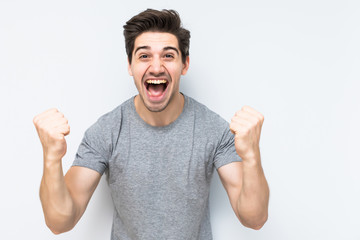 Portrait of smiling man with the fists up isolated a white background