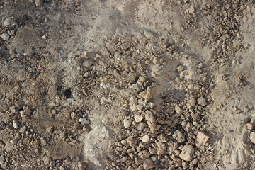 Construction site detail with sand, cement, ground and stones, rubble top down