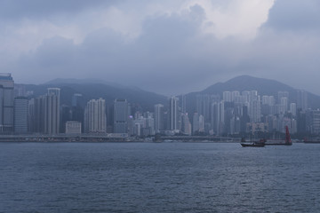 Fototapeta premium Hong Kong city landscape day and evening with lights. Skyscrapers overlooking the mountains and the sea day and evening. Night lights. China