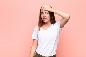 young red head woman panicking over a forgotten deadline, feeling stressed, having to cover up a...