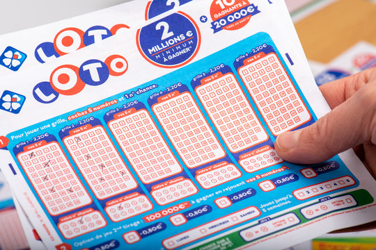 Paris, France -  November 21, 2019 : Closeup of french grids of lotto ,La francaise des jeux, in a person's hand