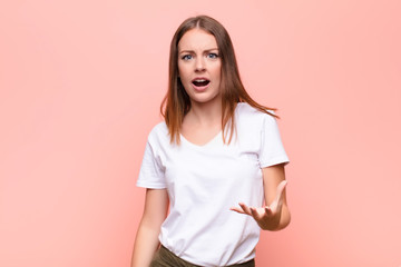 young red head woman looking angry, annoyed and frustrated screaming wtf or what‚Äôs wrong with...