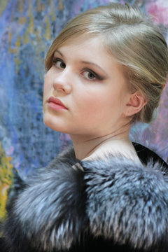 girl - teenager, natural blonde in a chic fur coat from silver fox