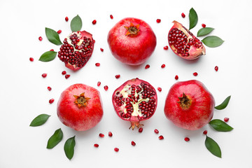 Ripe tasty pomegranates on white background