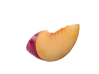 Slice of smooth-skinned, purple plum fruit without kernel isolated on white background with copy space for text or images. Side view. Close-up shot.